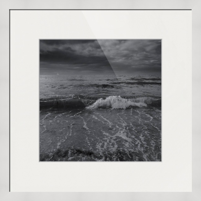 Black and white ocean photograph on white frames