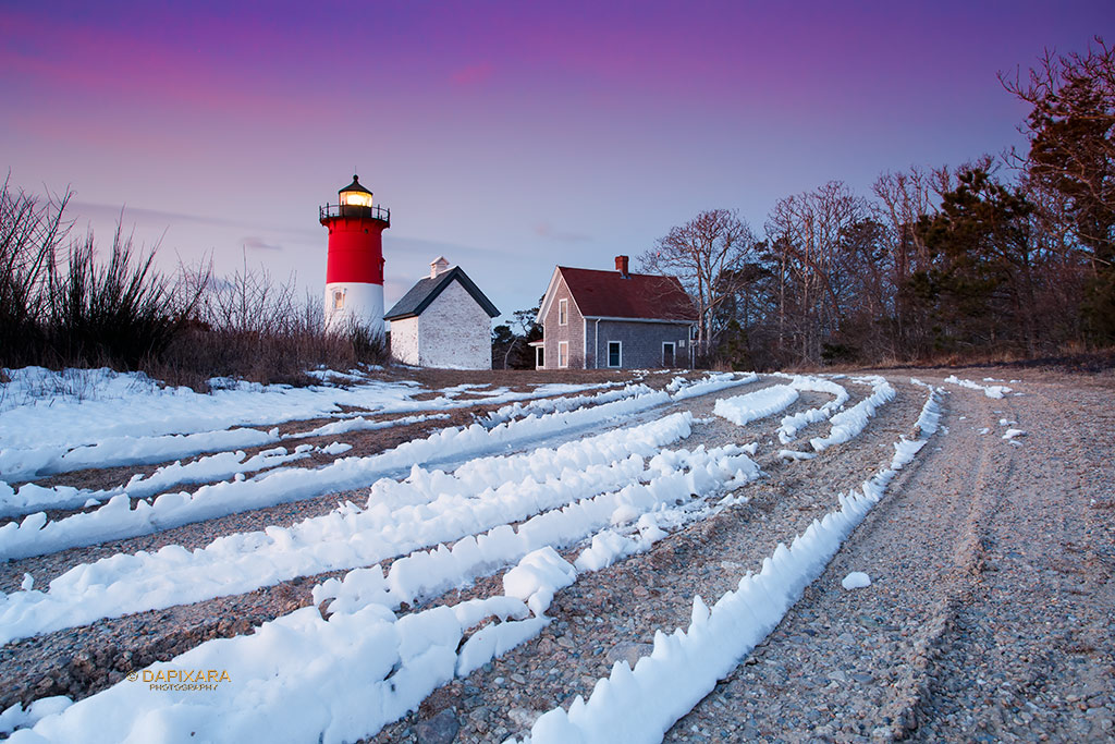A winter sunrise lights up the sky this morning behind the Nauset Light.  Winter sunrise, Nauset Lighthouse, Eastham, Cape Cod. © Dapixara.
