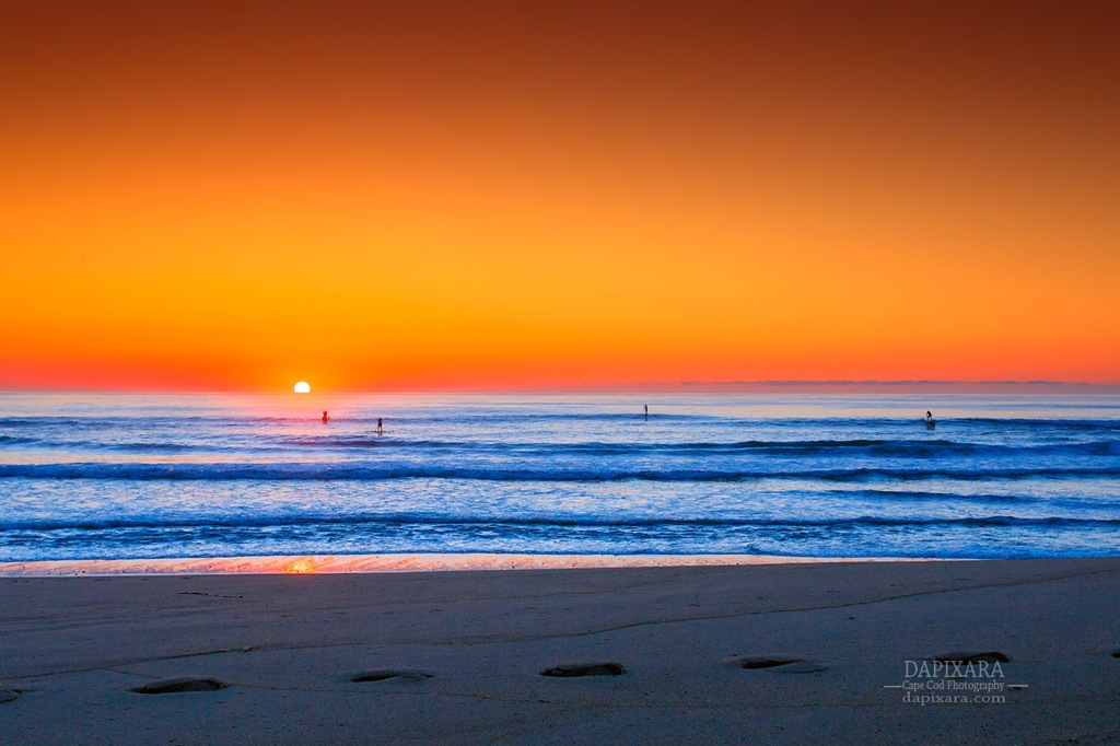 Paddling in to Sunrise. A spectacular Ocean sunrise behind a stand up paddlers in Cape Cod. Dapixara photography.
