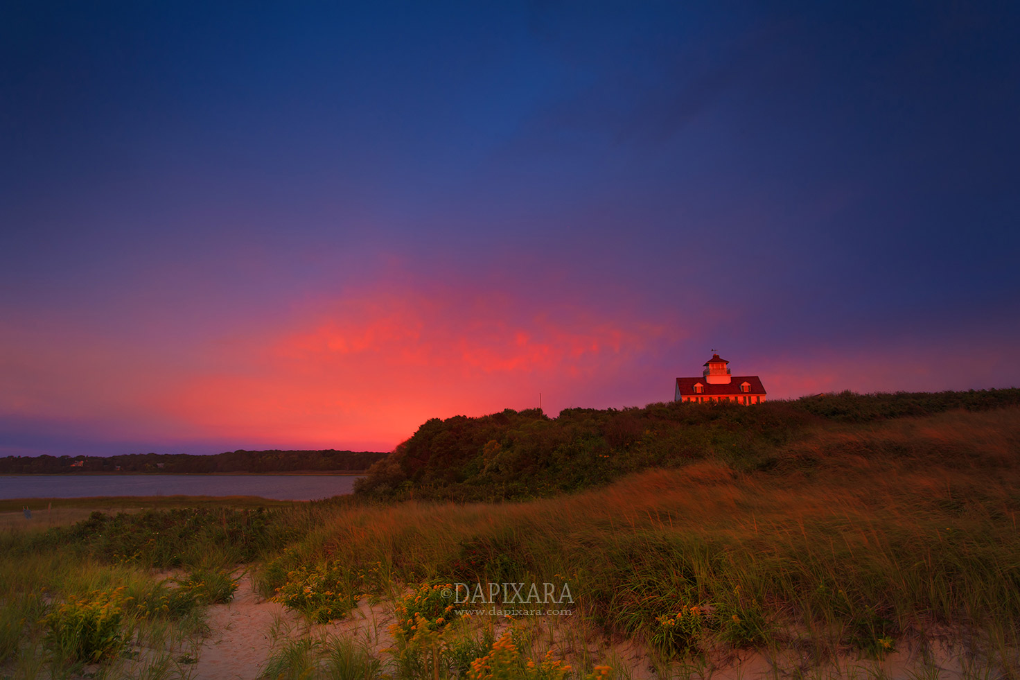 Purple sky over Coast Guard station in Eastham, Massachusetts. Photographer © Dapixara.